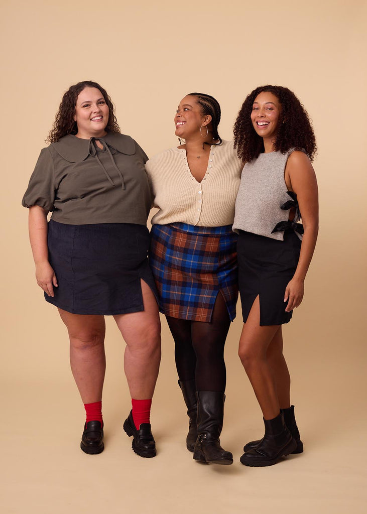 a group of three women wearing different colours of miniskirts