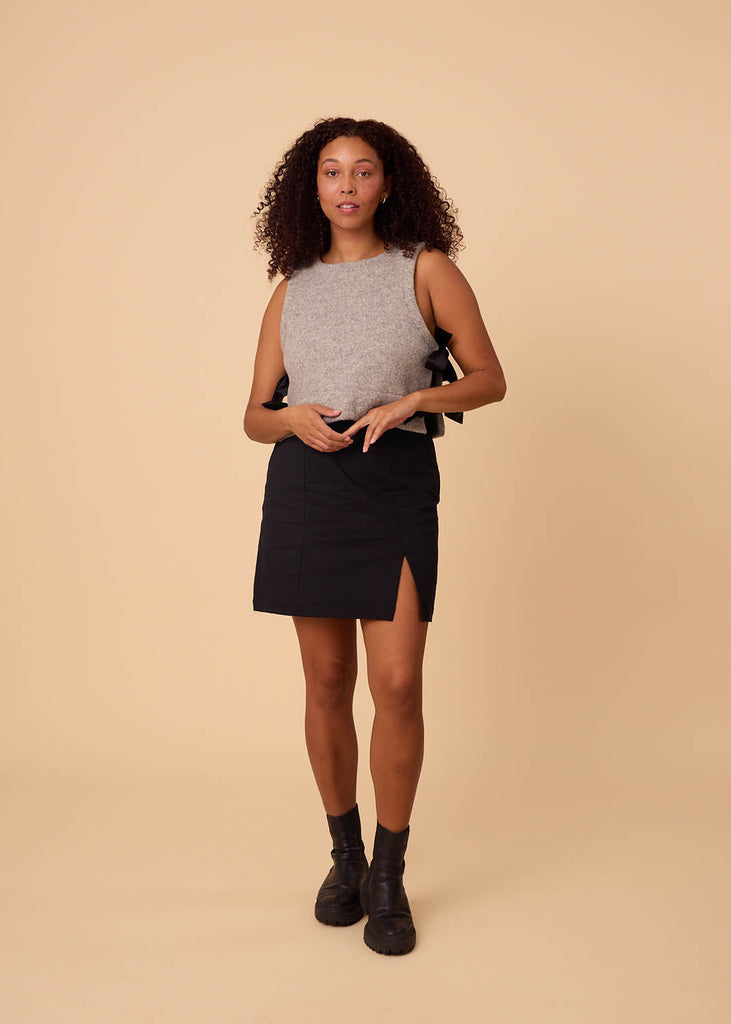 a straight size woman wearing a black miniskirt