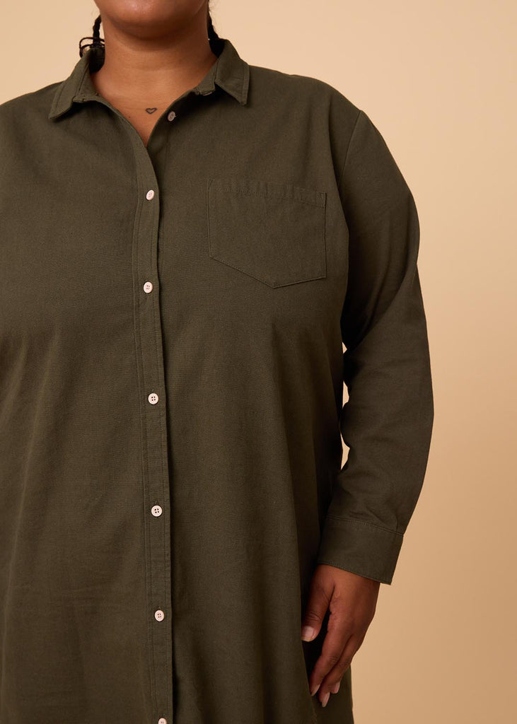 closeup of a plus size person in an olive green shirt dress