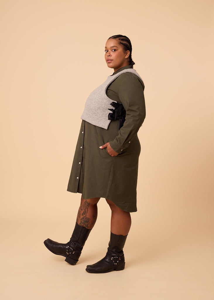 plus size person in an olive green shirt dress under a grey vest