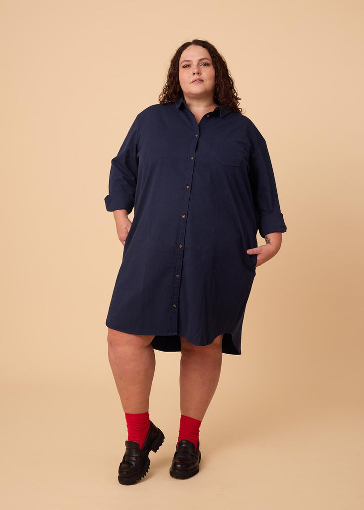 plus size person in a navy shirt dress