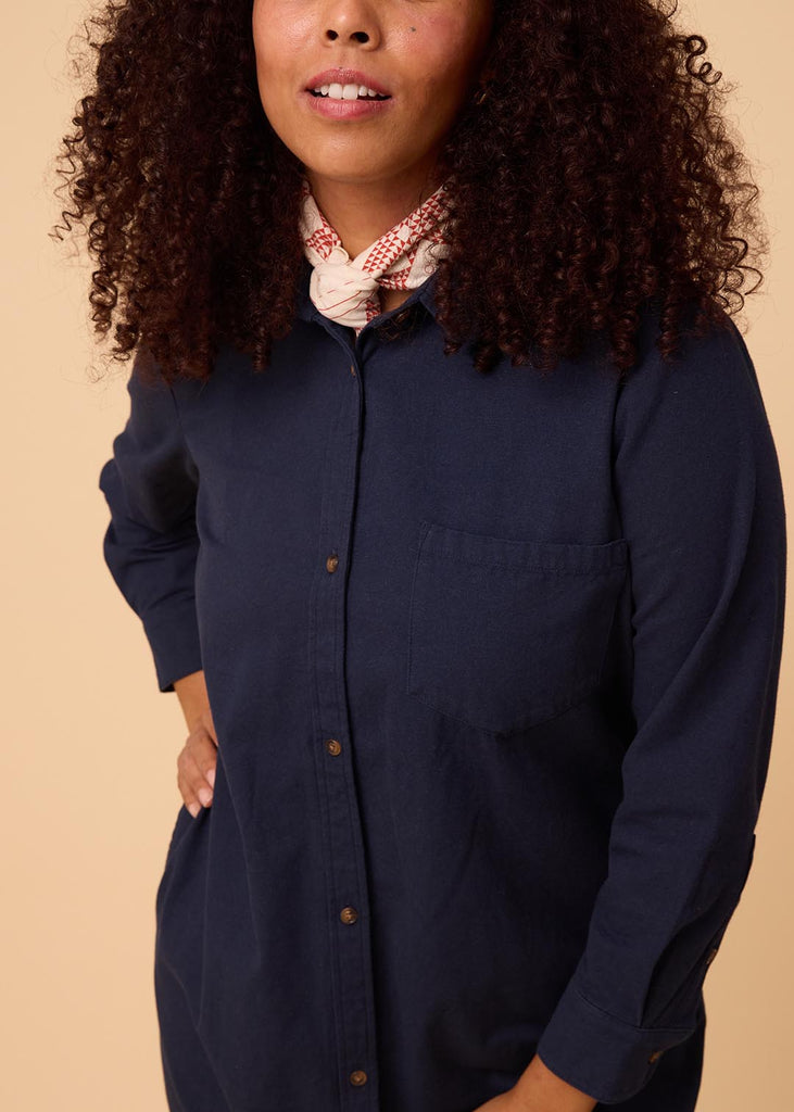 close up of a straight size woman in a navy shirt dress