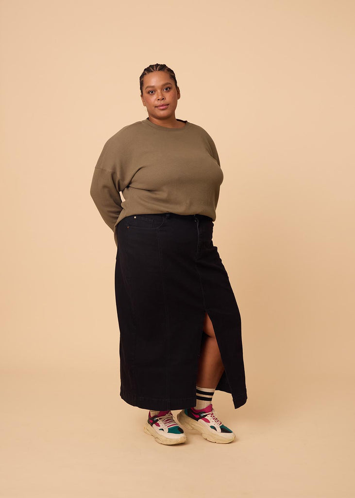 plus size woman wearing olive green long sleeve waffle top