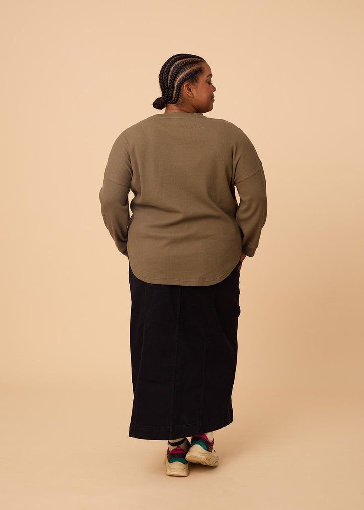 plus size woman wearing olive green long sleeve waffle top