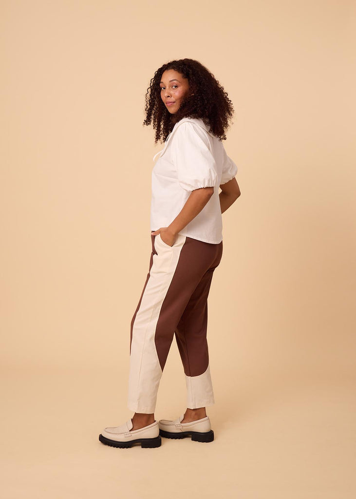 a straight sized woman wearing brown and white pants