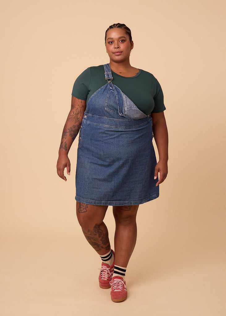 plus size woman in a deep green tee shirt