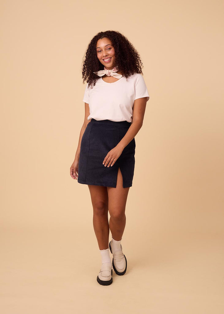 a straight size woman wearing a navy miniskirt