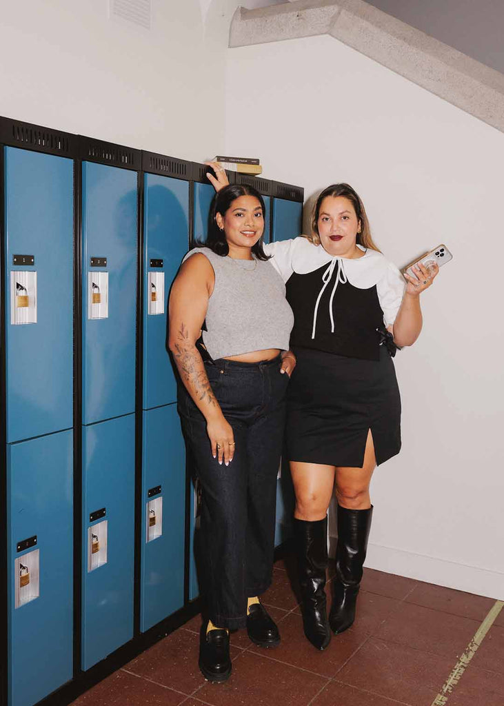 two woman posing in matching wool vests