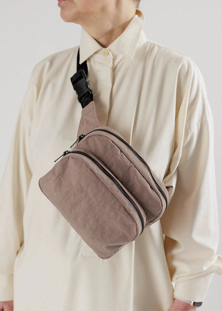 a close up shot of a person wearing a fanny pack crossbody 