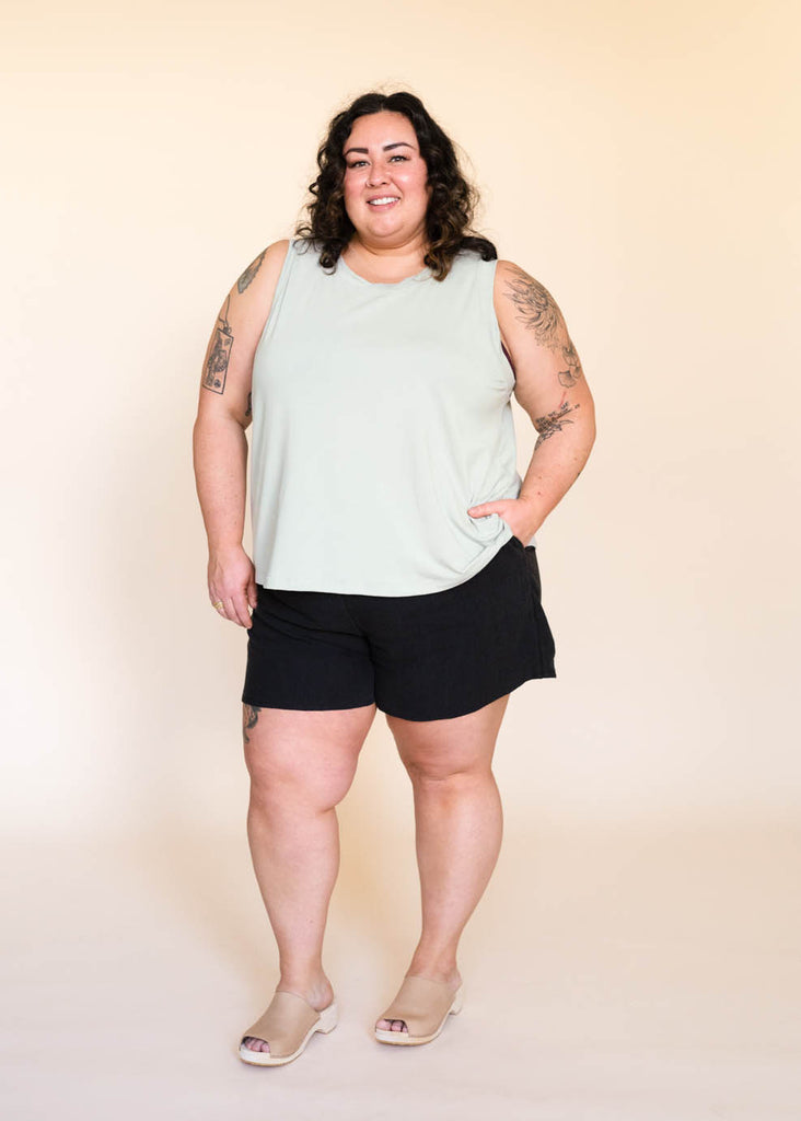 a plus size woman wearing a sage tank top