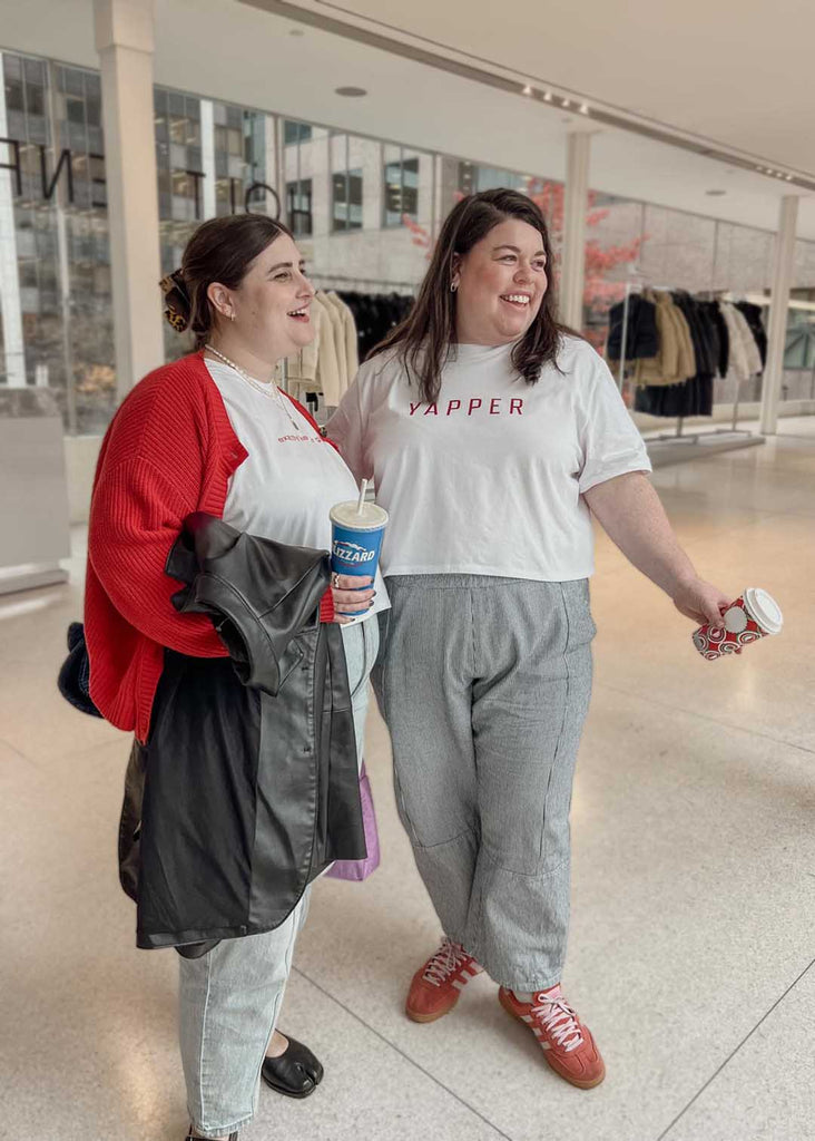 two plus size women wearing a white cropped graphic tees