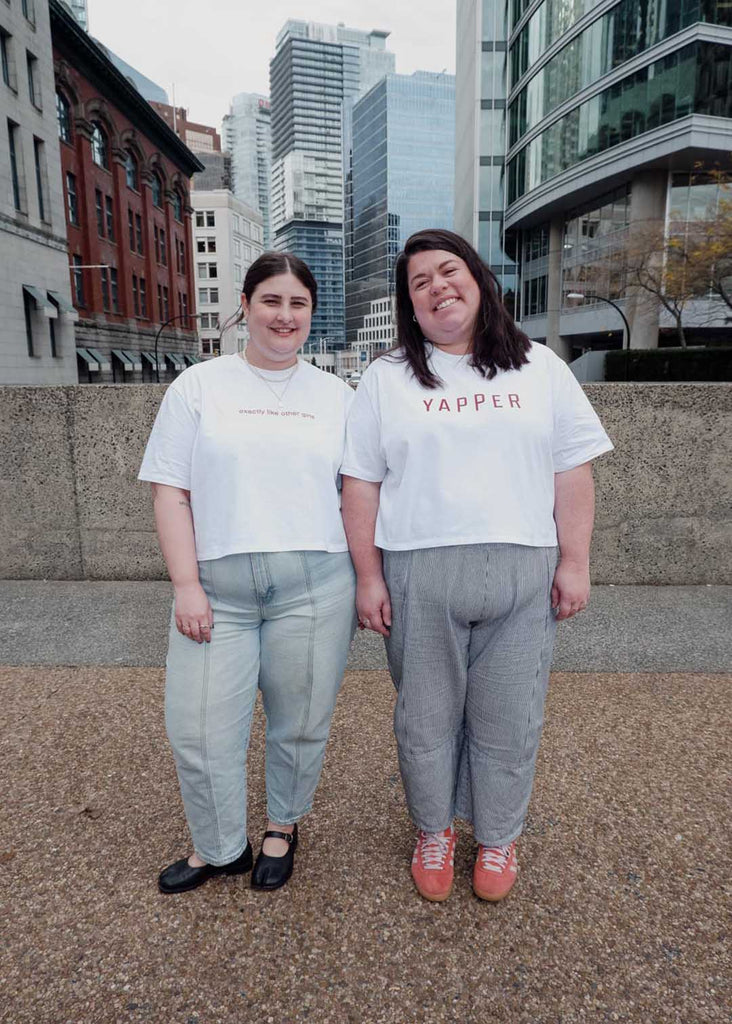 two plus size women wearing white cropped graphic tees