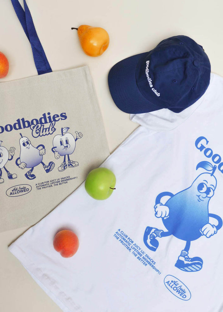 a shot of a tote bag, baseball cap and t-shirt all with the good bodies club logo