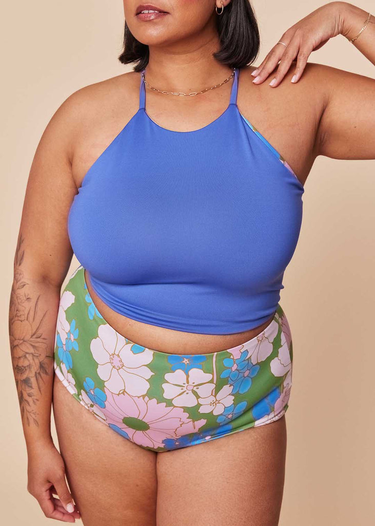 a mid size woman wearing a mix and match two piece bathing suit