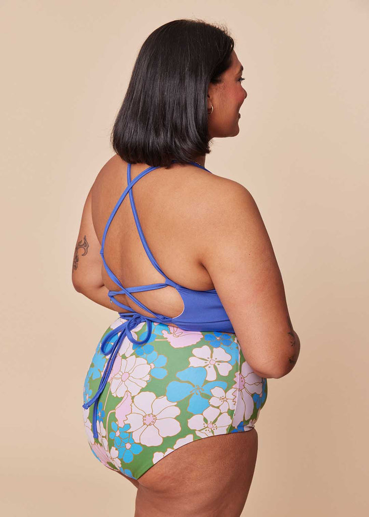 a mid size woman wearing a mix and match two piece bathing suit