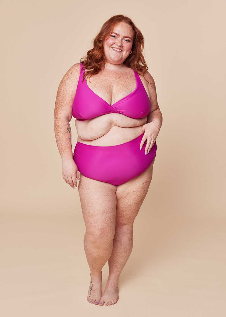 a plus size woman in a pink bikini