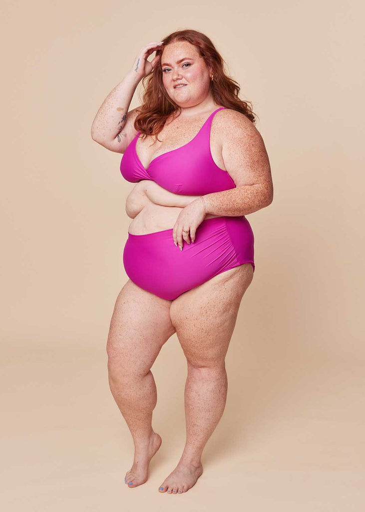 a plus size woman in a pink bikini