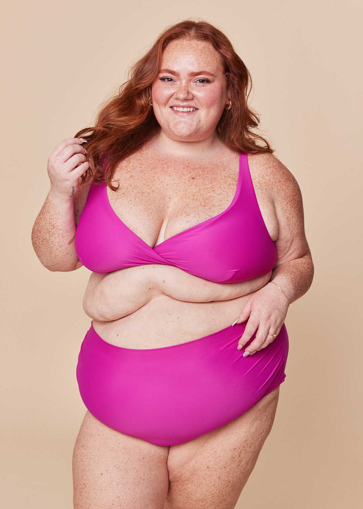 a plus size woman in a pink bikini