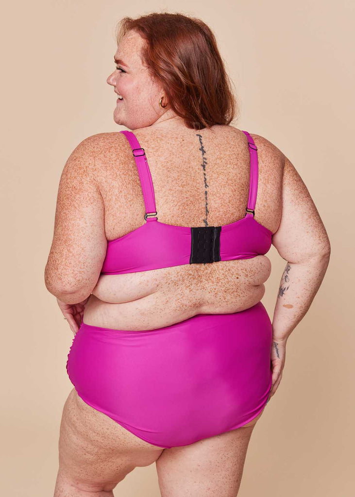 a plus size woman in a pink bikini