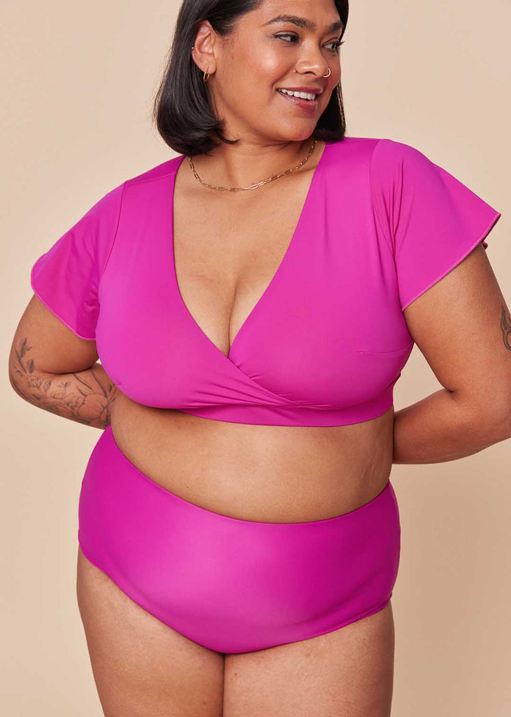 a mid size woman wearing a pink bikini