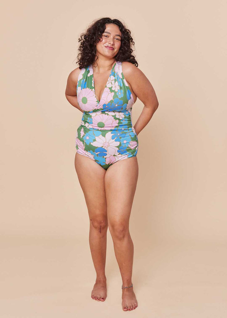 a straight size woman wearing a floral one piece swimsuit