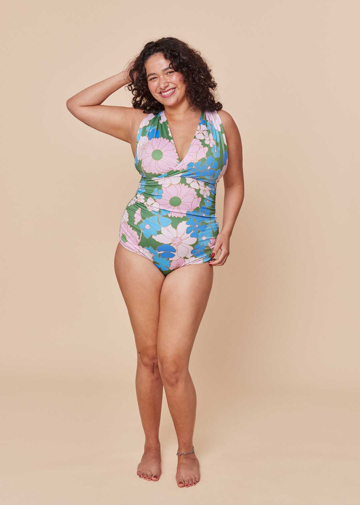 a straight size woman wearing a floral one piece swimsuit