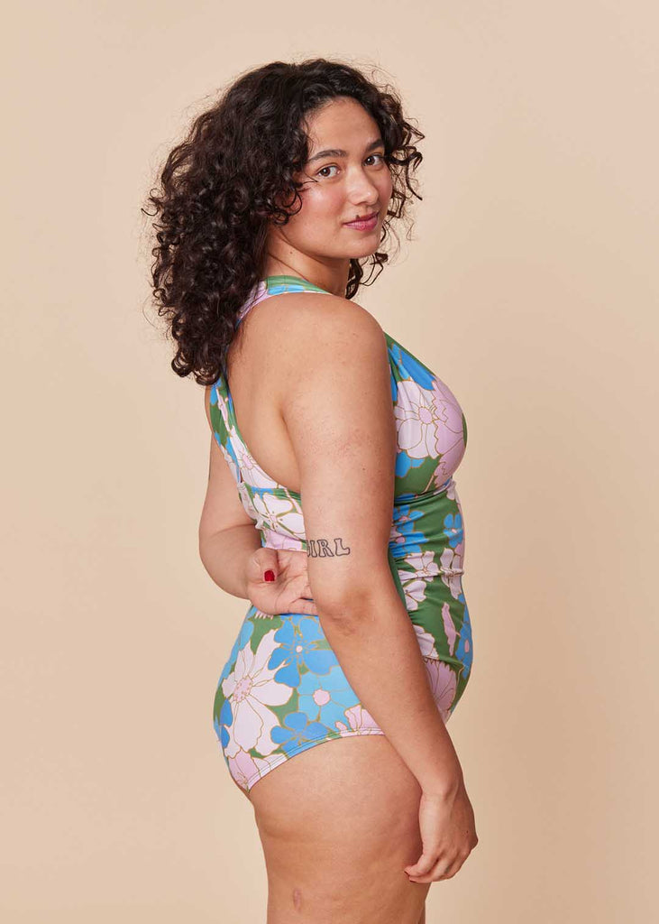 a straight size woman wearing a floral one piece swimsuit