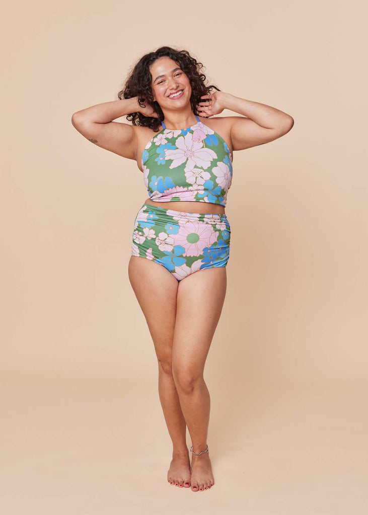 a straight size woman wearing a floral two piece bathing suit