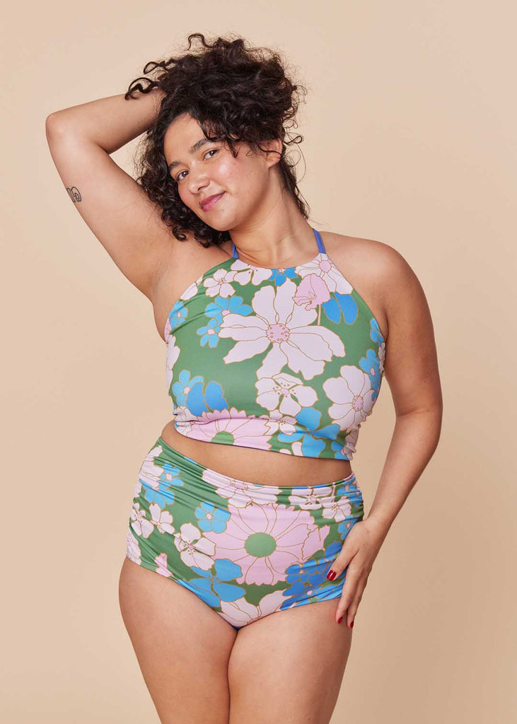 a straight size woman wearing a floral two piece bathing suit