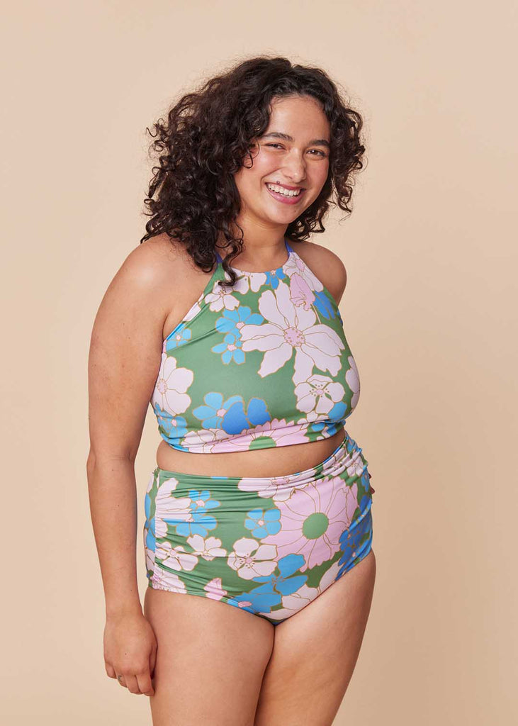 a straight size woman wearing a floral two piece bathing suit