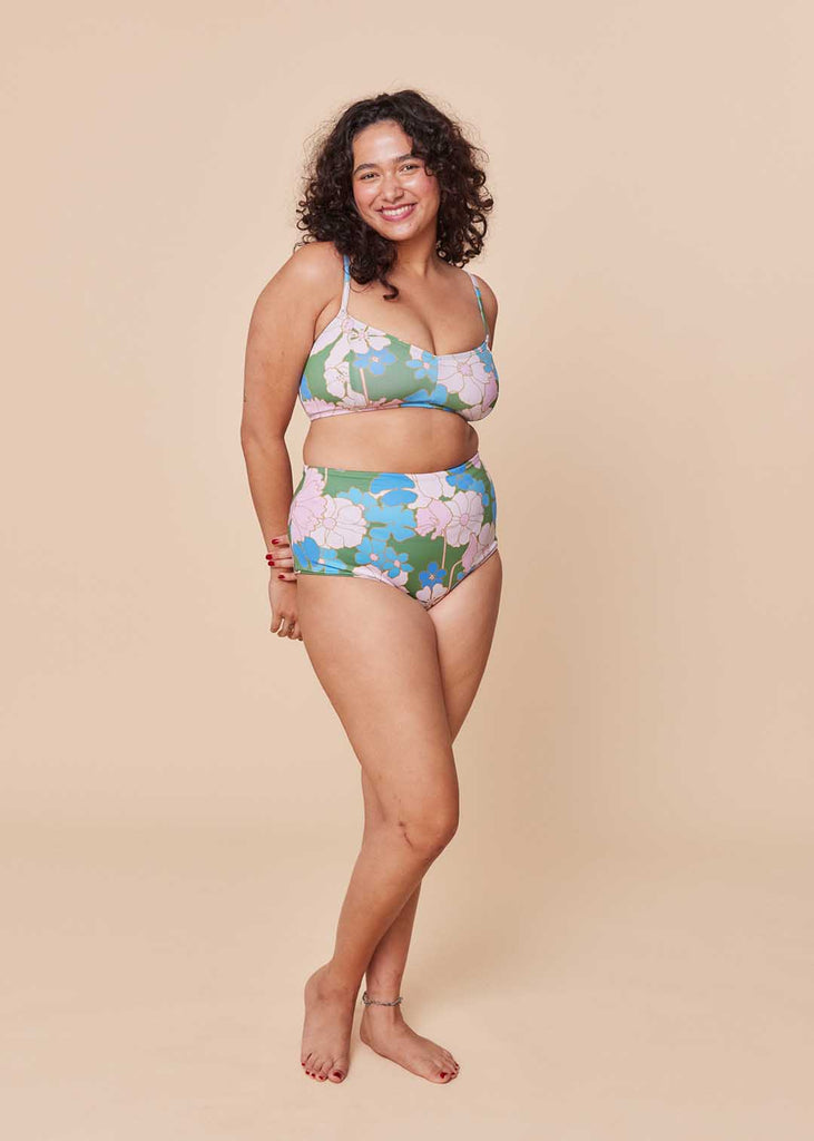 a plus size person in a floral two piece bathing suit