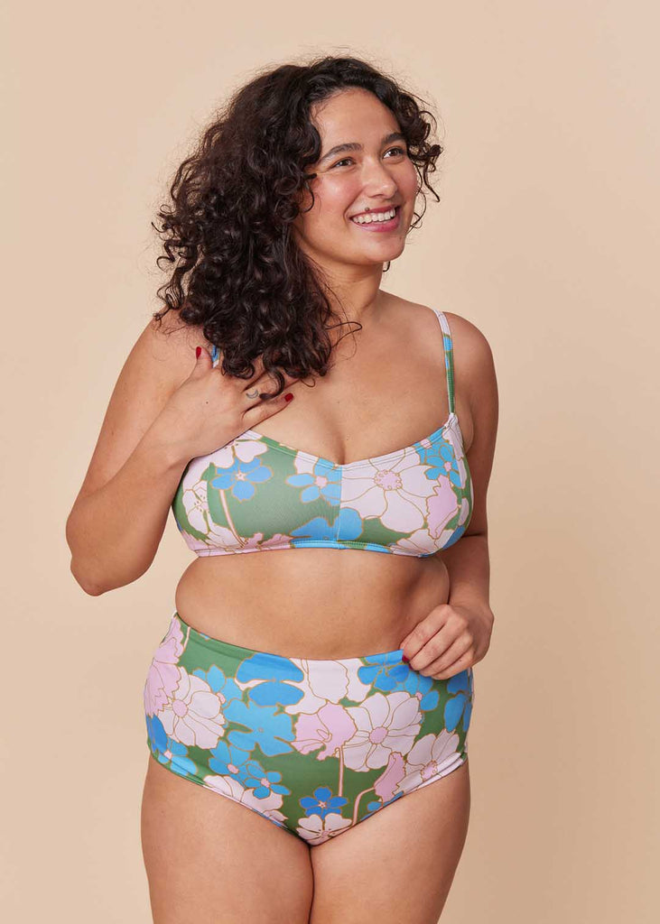 a mid size person in a floral two piece bathing suit