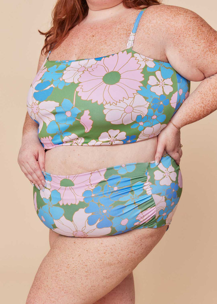 a plus size woman wearing a floral two piece swimsuit