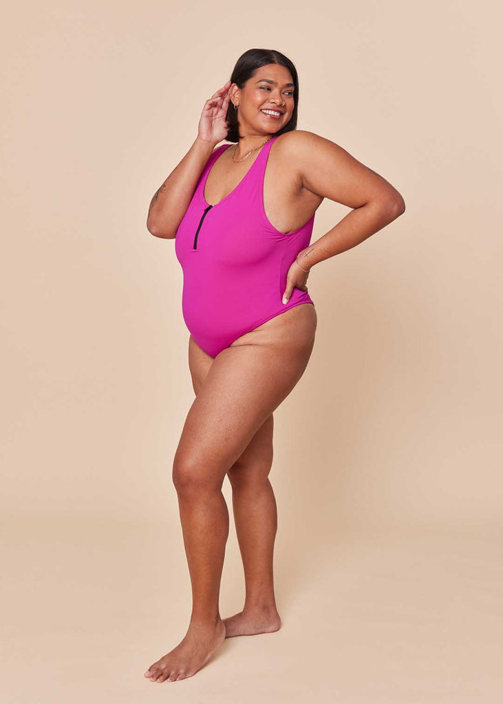 a mid size woman in a pink one piece swimsuit