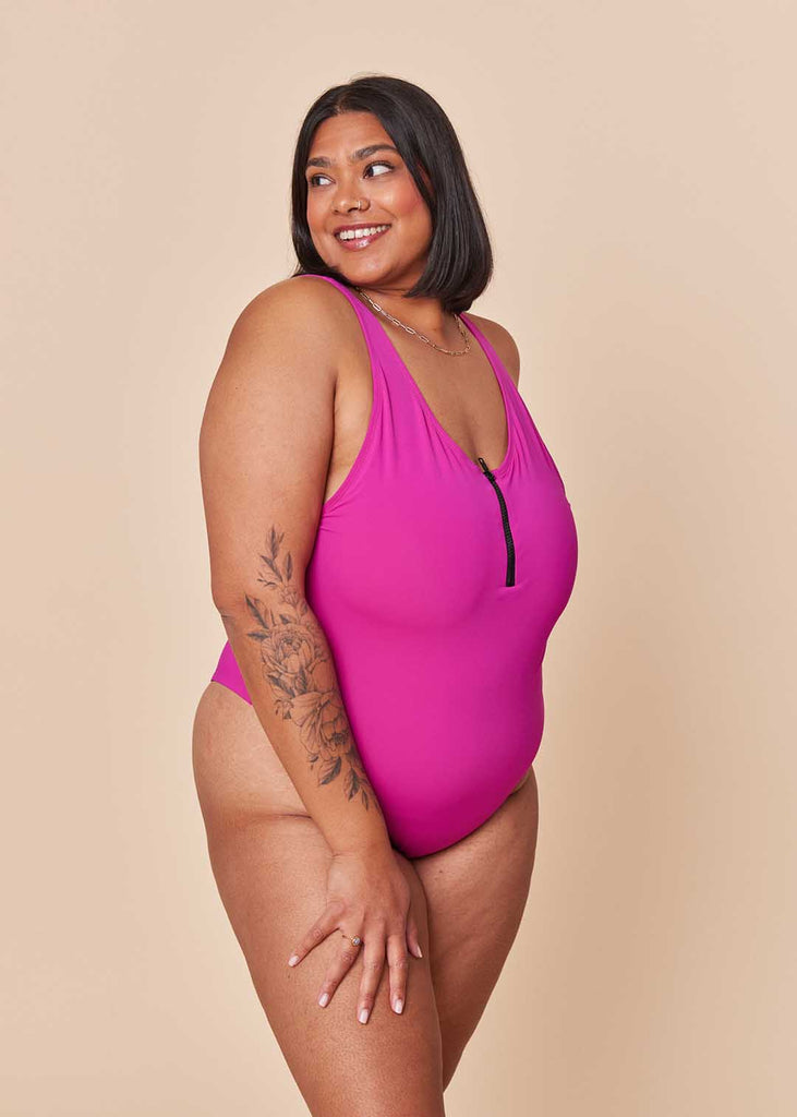 a mid size woman in a pink one piece swimsuit