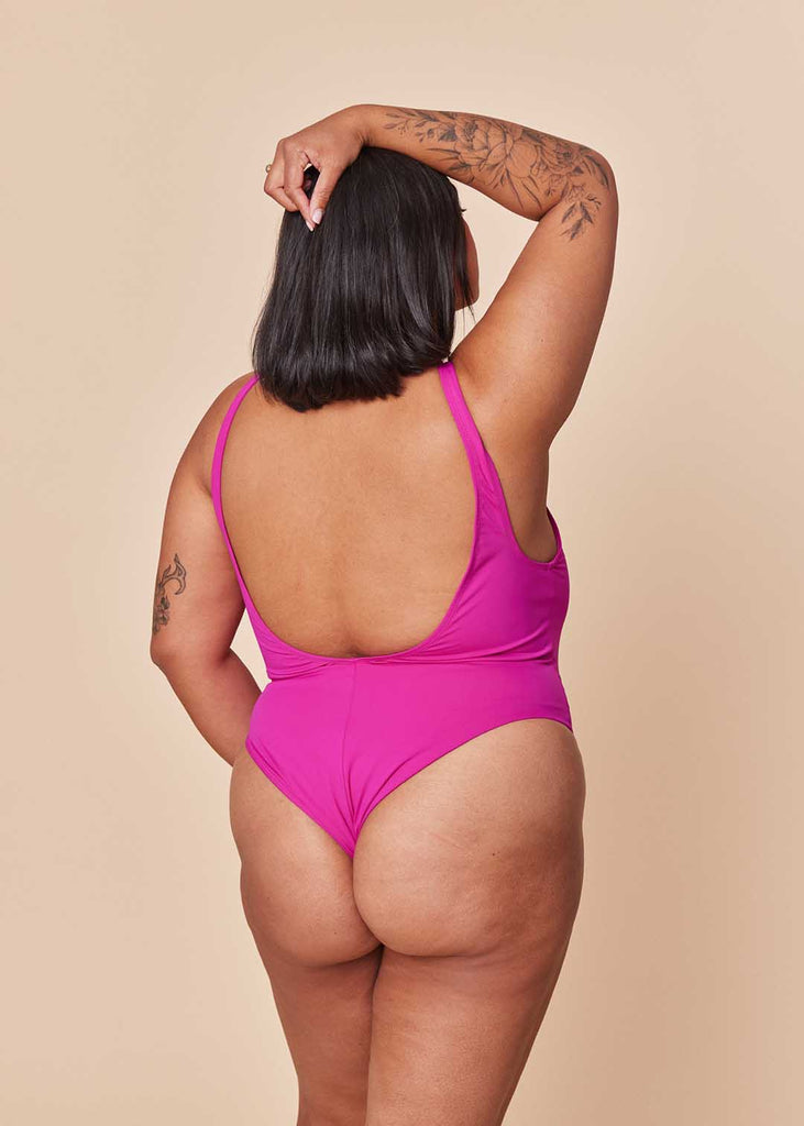 a mid size woman in a pink one piece swimsuit