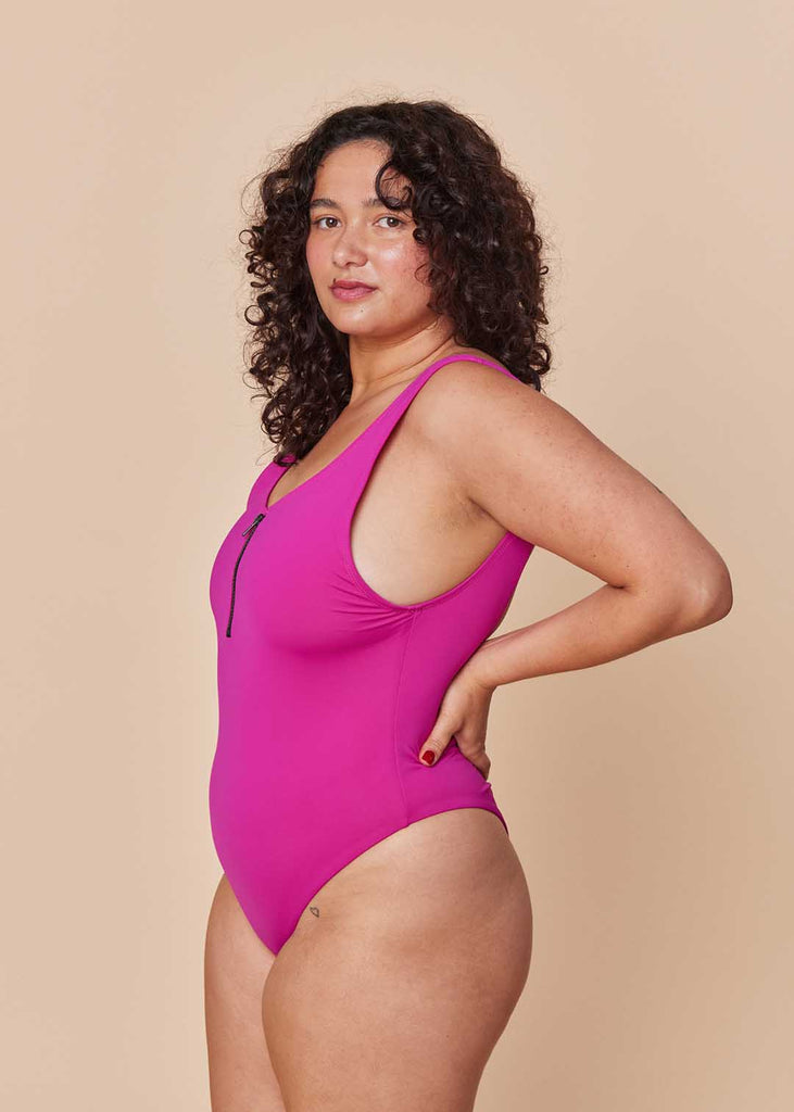 a straight size woman in a pink one piece swimsuit