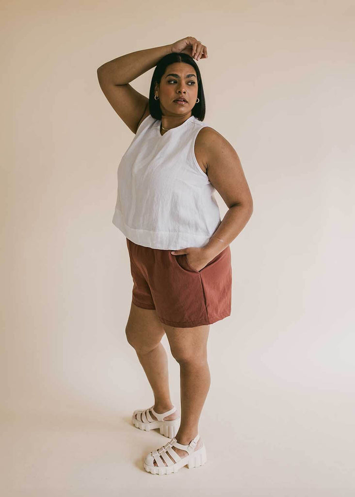 a plus size woman wearing brown shorts