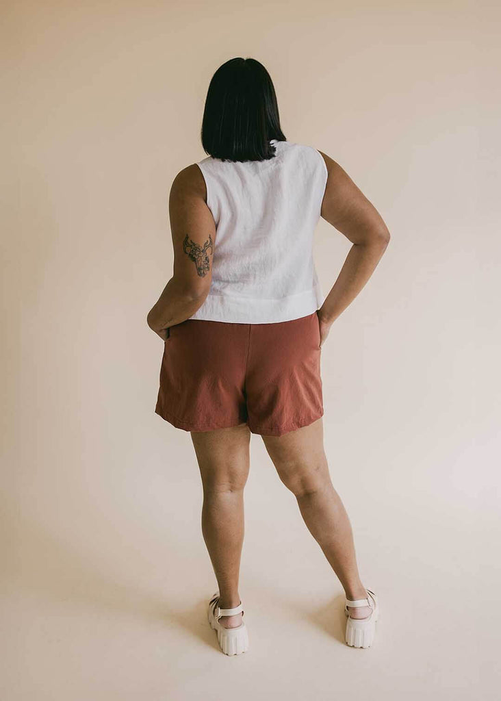 a mid size woman wearing a white tank top