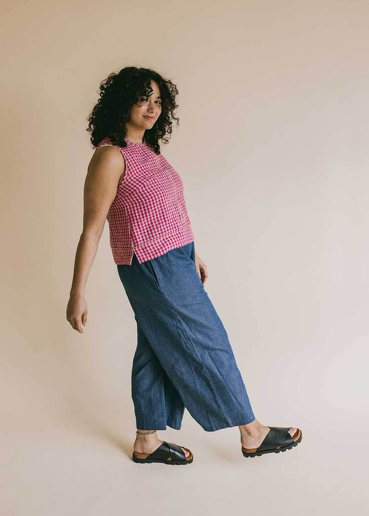 a mid size woman wearing a red gingham tank top