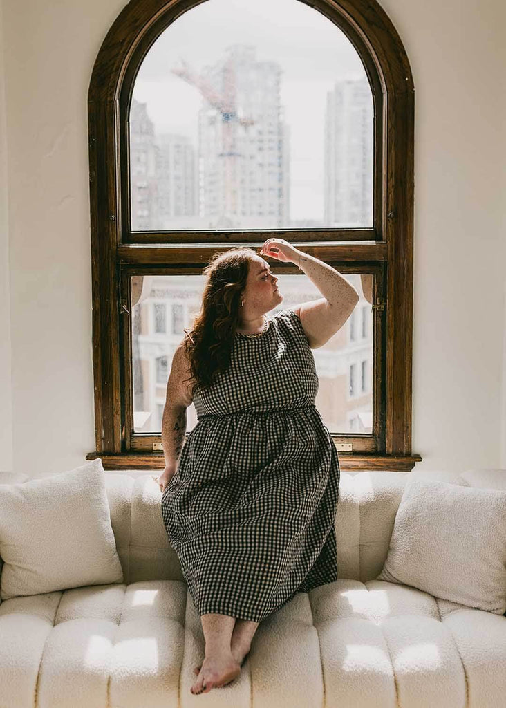 a plus size woman wearing a gingham sundress