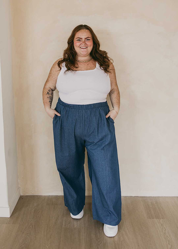 plus size woman wearing cropped white tank top