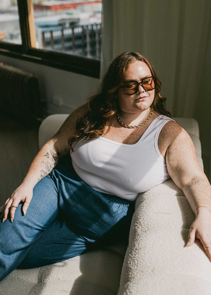 plus size woman wearing cropped white tank top