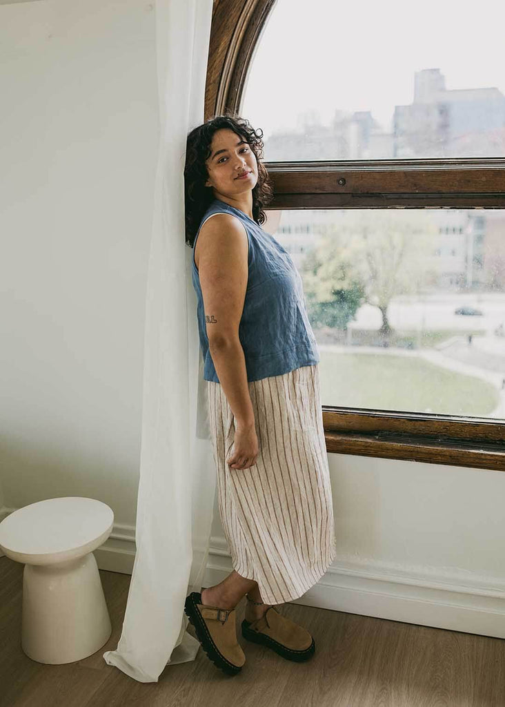 a midsize woman wearing a striped midi skirt