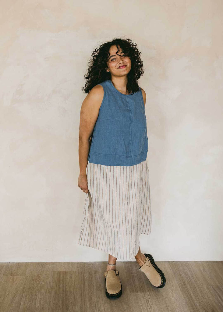 a midsize woman wearing a striped midi skirt