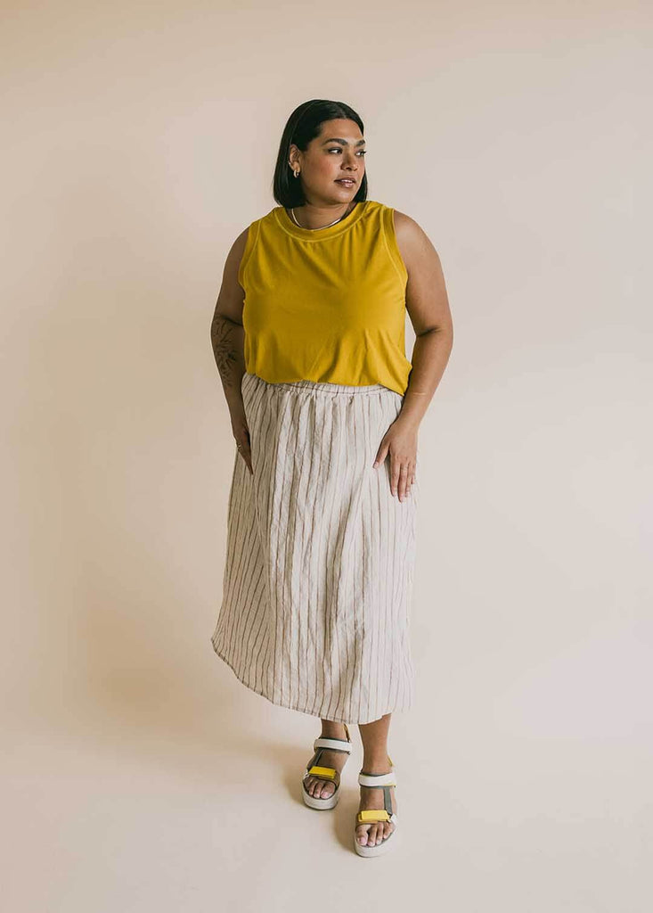 a mid size woman wearing a striped midi skirt
