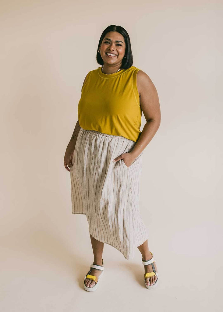 a mid size woman wearing a striped midi skirt
