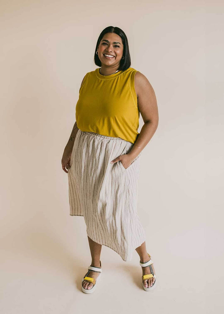a mid size woman wearing a yellow tank top