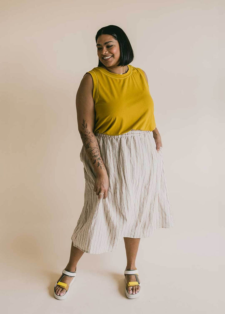 a mid size woman wearing a yellow tank top