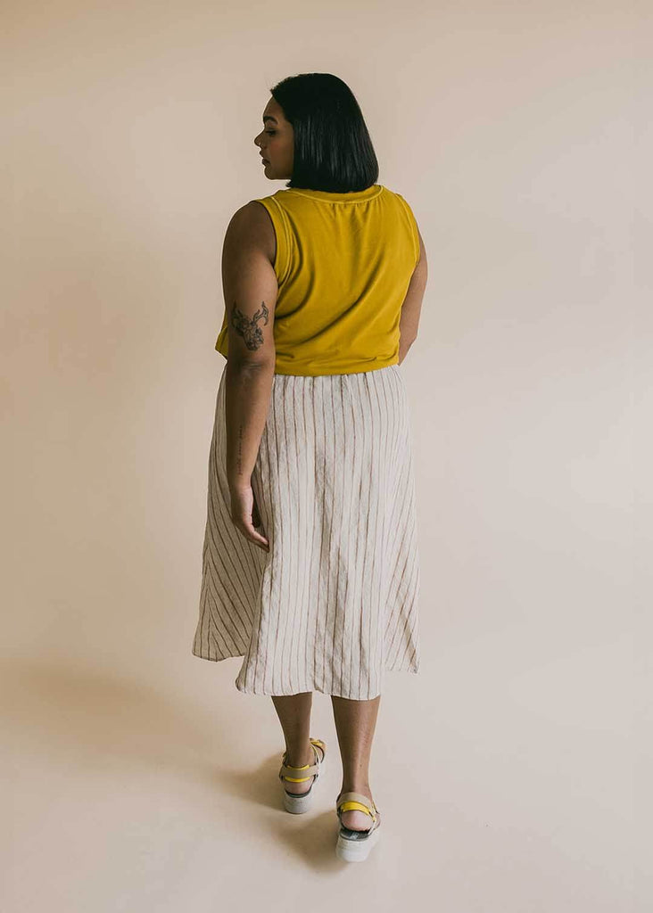 a mid size woman wearing a striped midi skirt